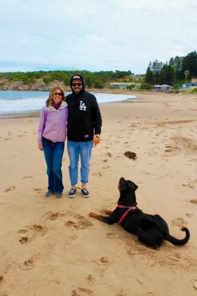 Brother and sister on the beach with their dog